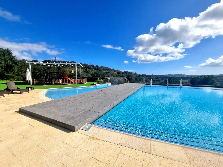 Infinity pool with pergola overlooking Algarve landscape